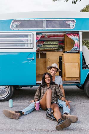 Couple sitting outside infront of RV