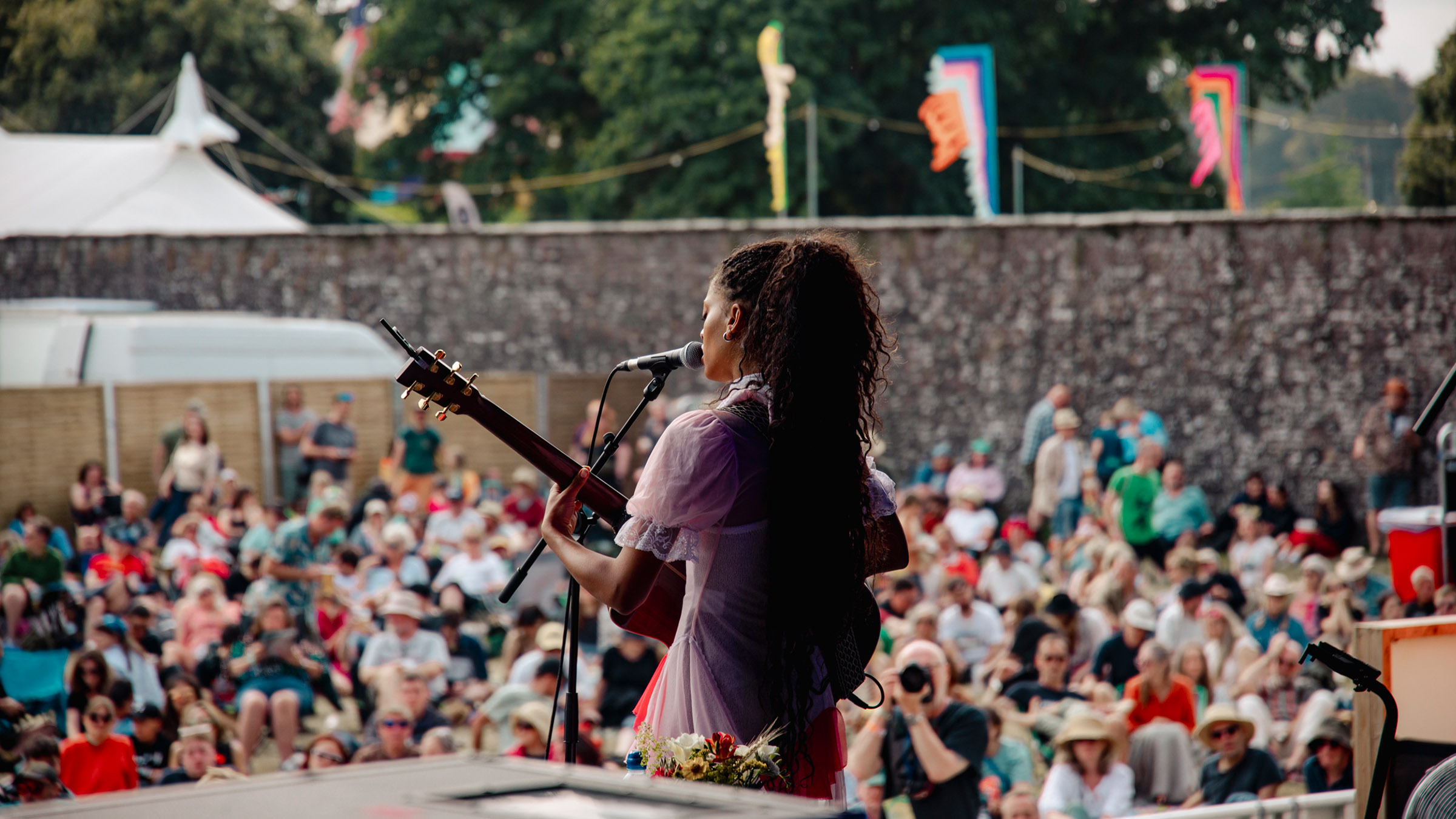 singer playing the guitar on stage