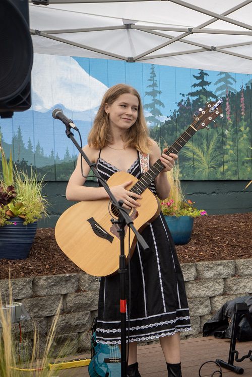 Rosahlee playing guitar