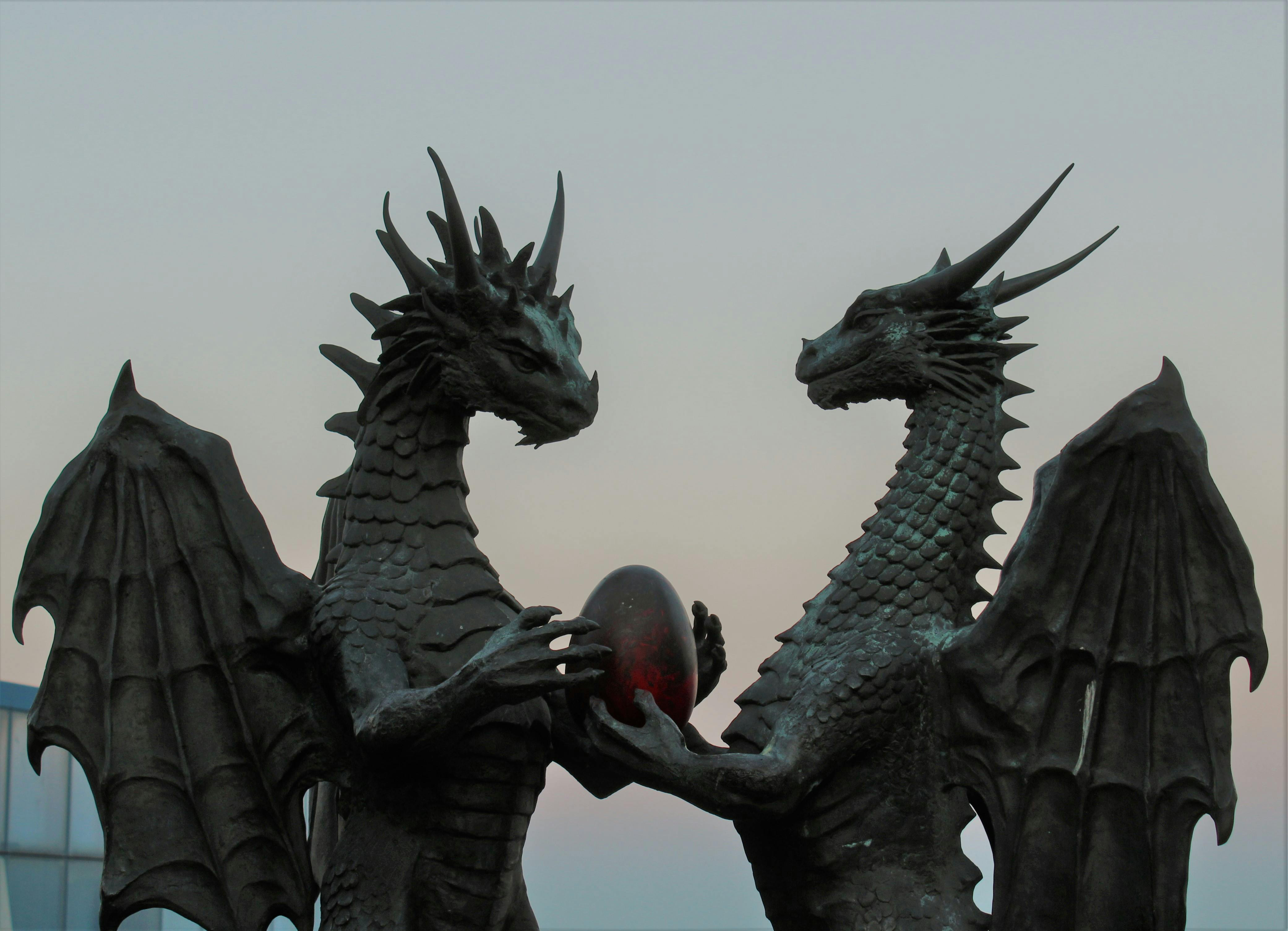 two dragons holding an egg