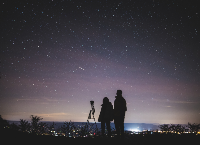 two peole, looking up at the night sky