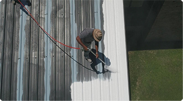 Person on roof restoring the roof.