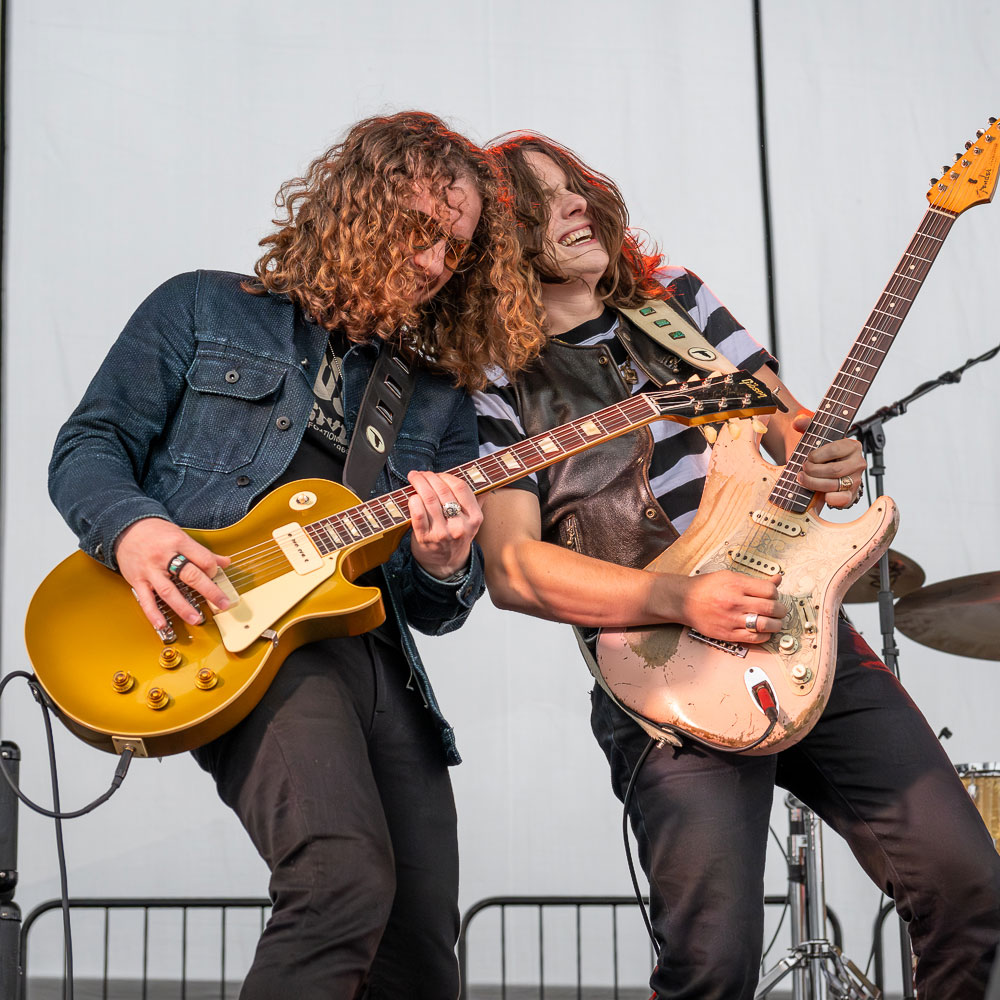 Tyler Bryant & The Shakedown playing their bass and electric guitar at the 2023 Oak Harbor Music Festival