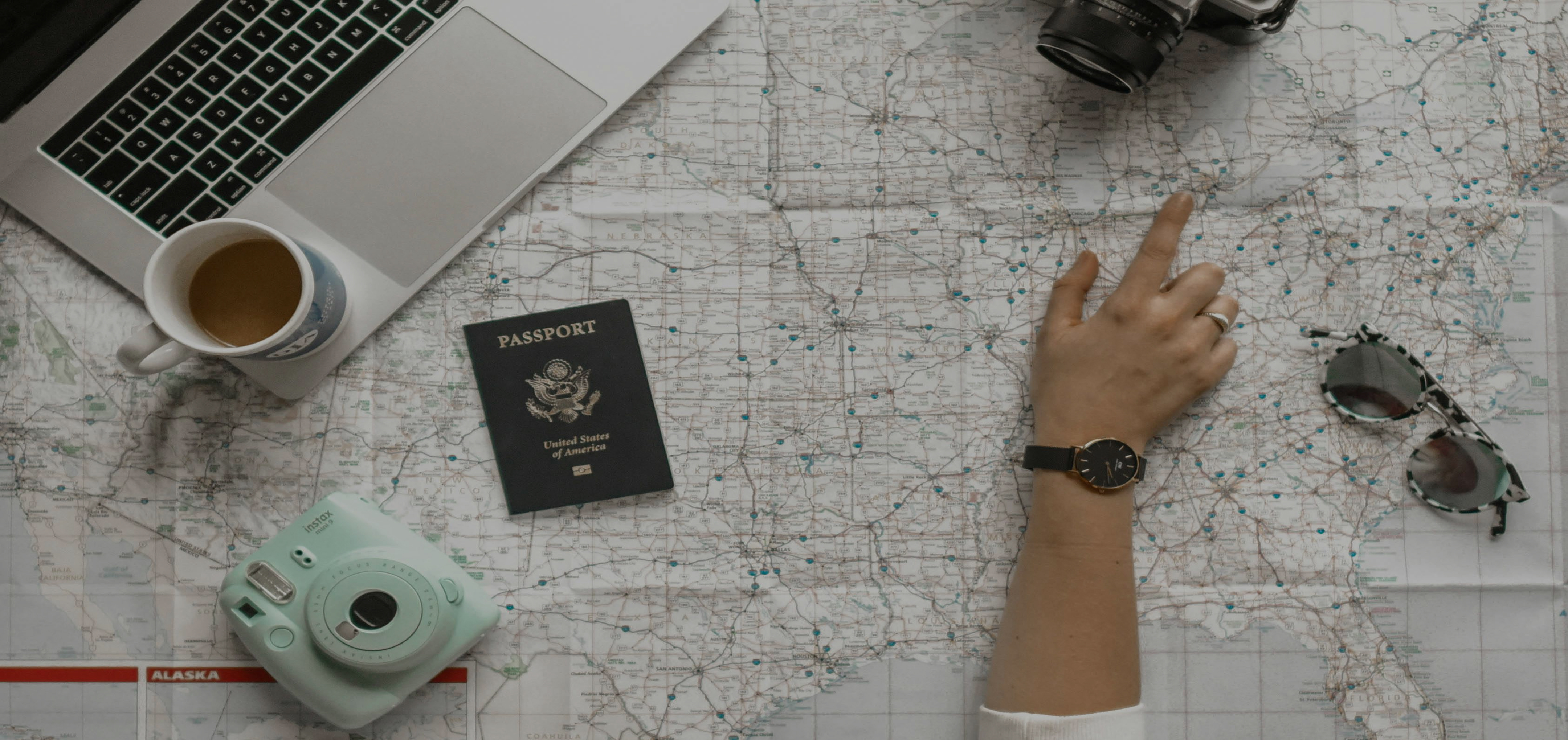 Travel planning with map, passport, and camera