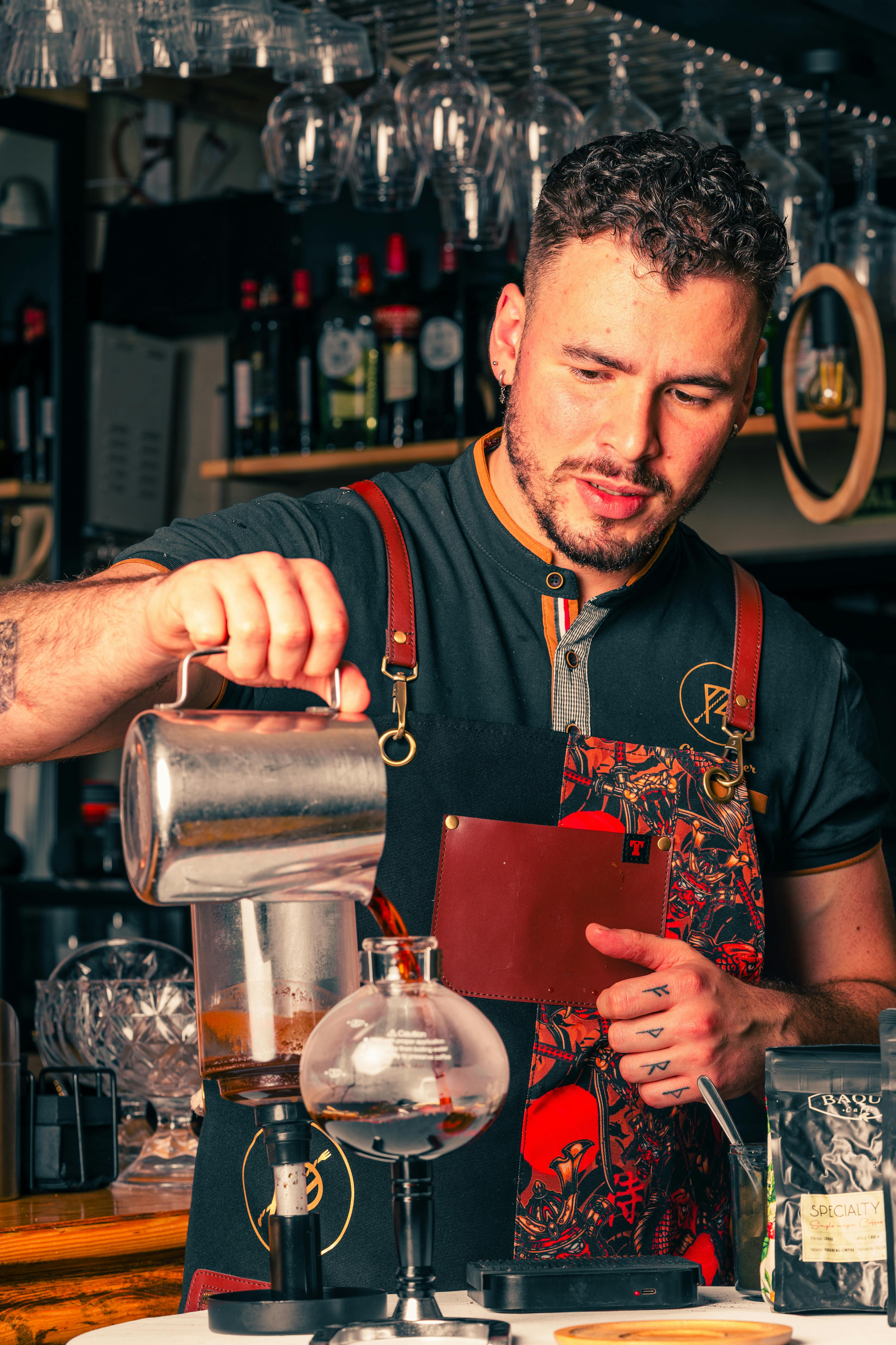 man pouring coffee into a brewing setup
